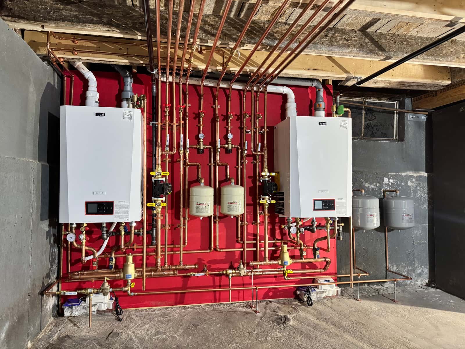 Twin Ideal high-efficiency boilers with new copper piping installed in a Lynnfield basement by Precision Plumbing Solutions