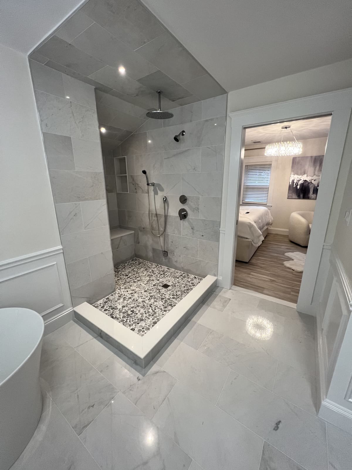 Marble walk-in shower, pebble floor — Precision Plumbing Solutions