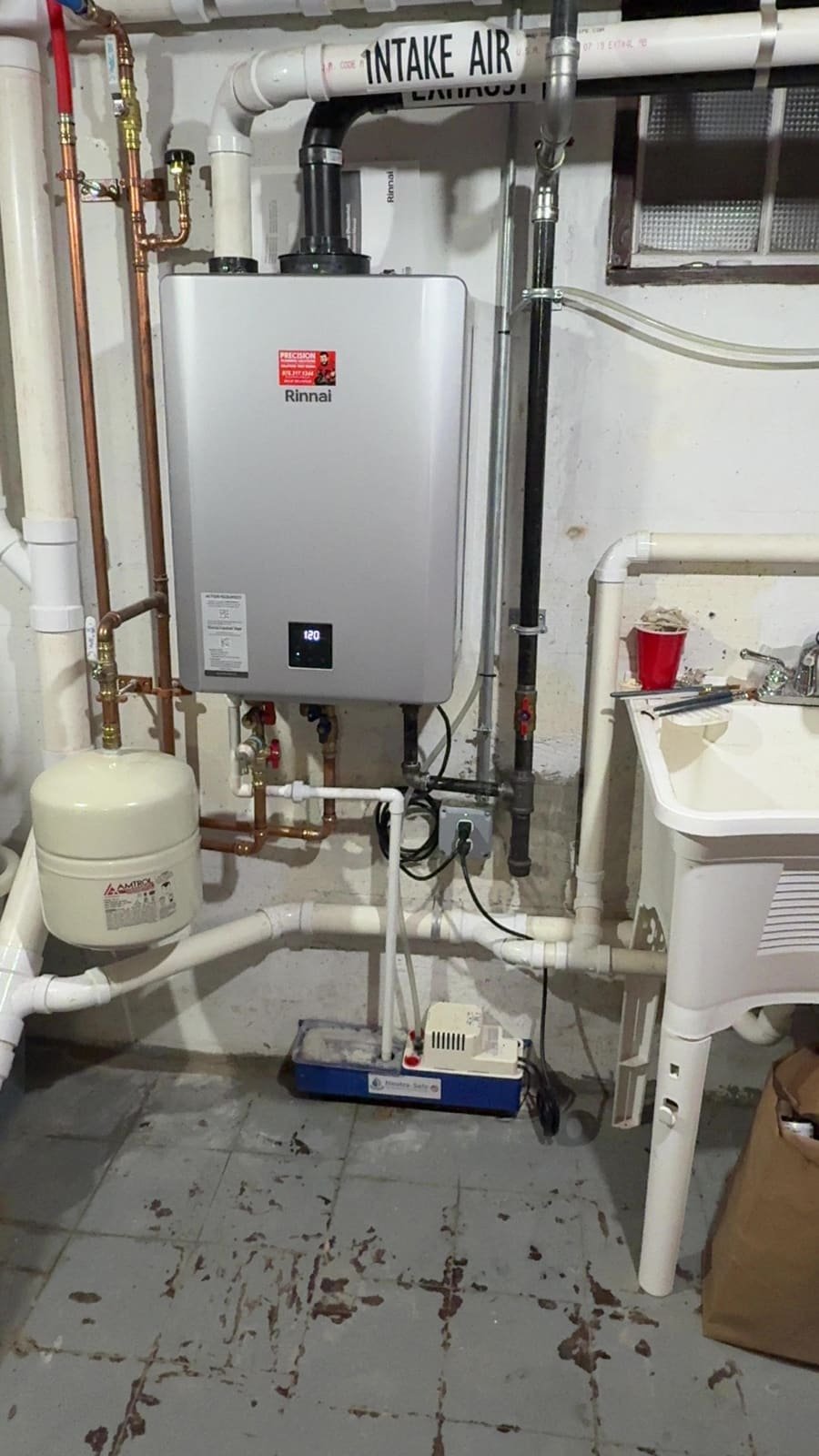 Gas tankless water heater with new gas and water lines installed by Precision Plumbing Solutions