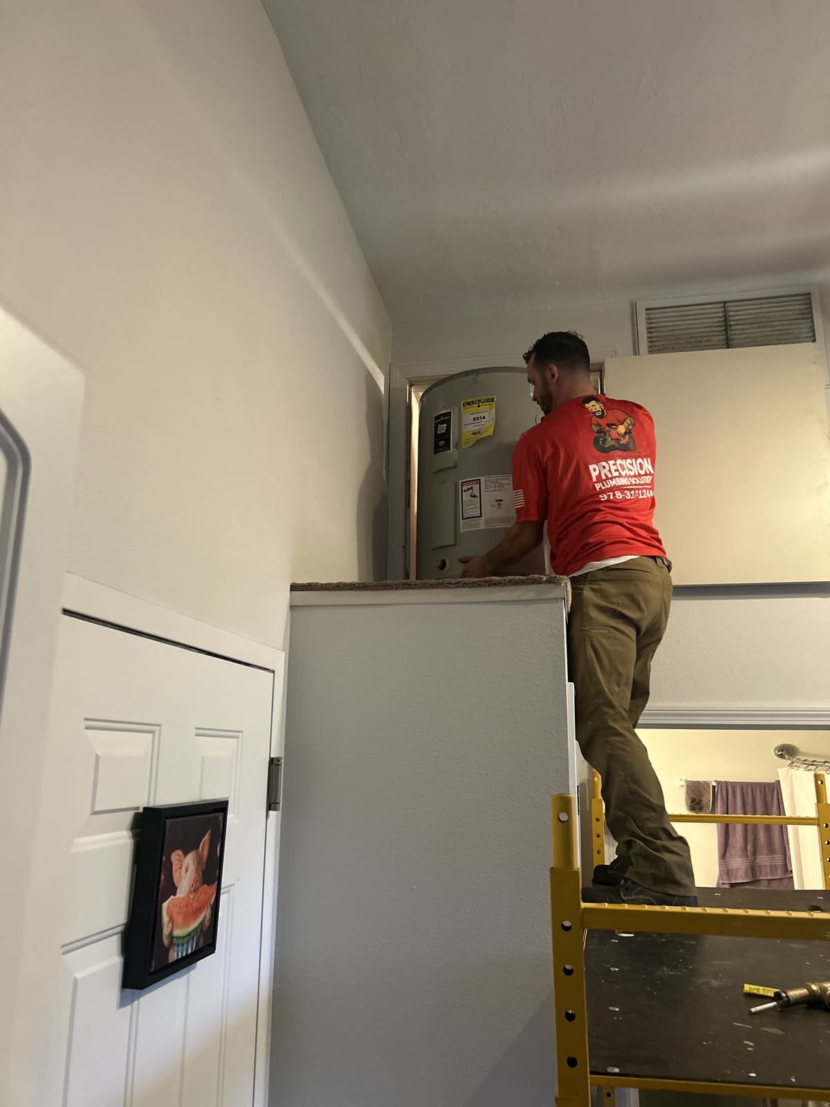 Precision Plumbing Solutions plumber working from a ladder