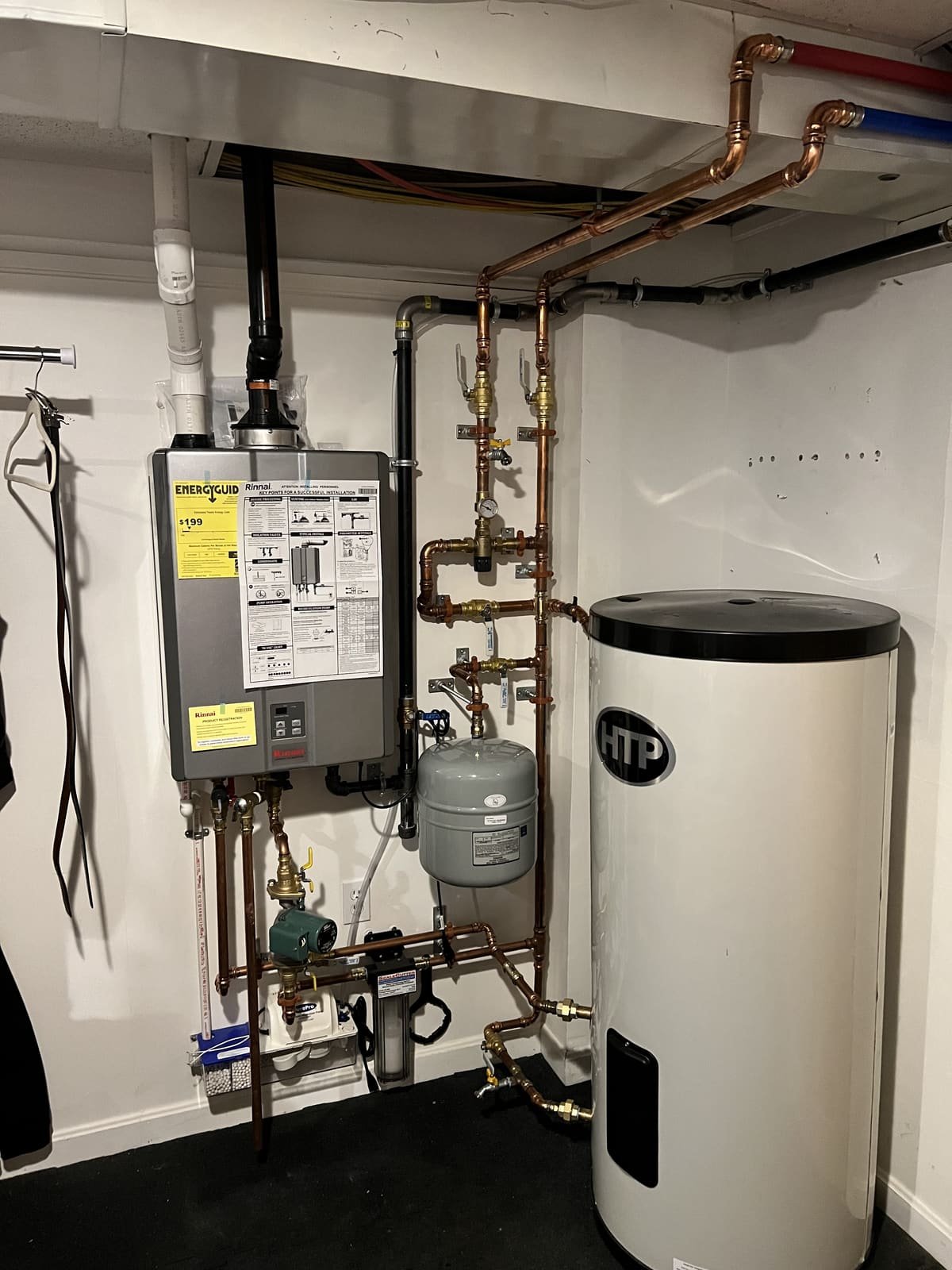 Tankless water heater and indirect storage tank with copper piping installed by Precision Plumbing Solutions