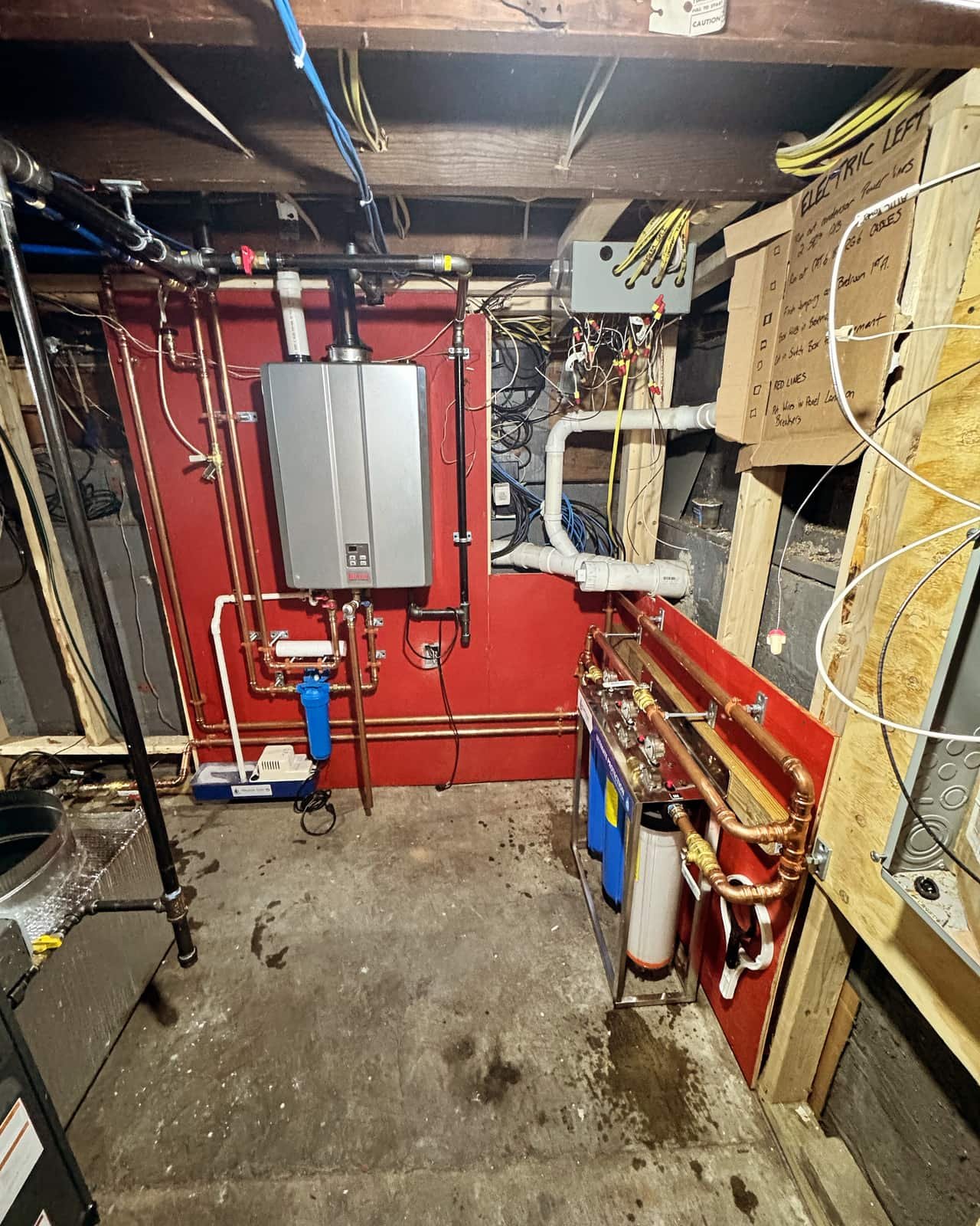 Water heater, filtration and supply lines serviced in a basement mechanical room by Precision Plumbing Solutions